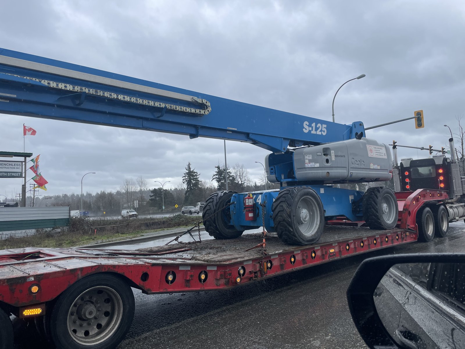 Genie S-125 on a lowbed trailer for delivery